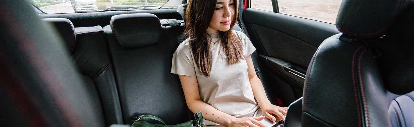 Woman Working in the back of a Car 1